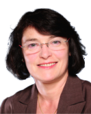 Headshot of a person with short dark hair and glasses, wearing a brown jacket, smiling